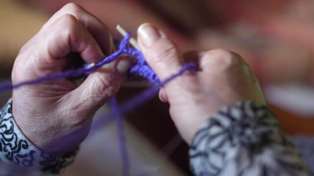 ederly woman hands Knitting doing crochet slow motion 4k