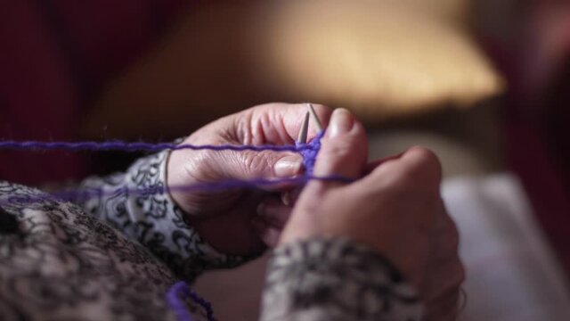 ederly woman hands Knitting doing crochet slow motion 4k