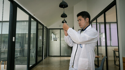 The image of a young male doctor holding a needle and is confident Concept of a successful medical career in his office