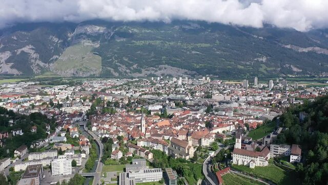 Aerial view of Chur townscape overlooking reformed church of St. Martin and Catholic Cathedral on summer day, canton of Graubunden, Switzerland. High quality 4k footage