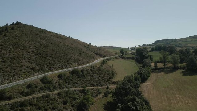 Aerial view following a mountain road on the countryside in Montella, La Cerdanya, Catalunya 4k