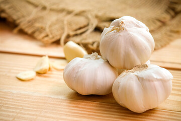 Garlic bulb head and cloves on wooden floor, Herbs and spices are important in cooking