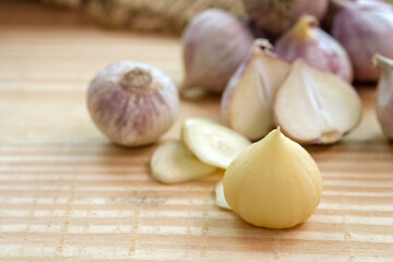 Garlic bulb head and cloves on wooden floor, Herbs and spices are important in cooking