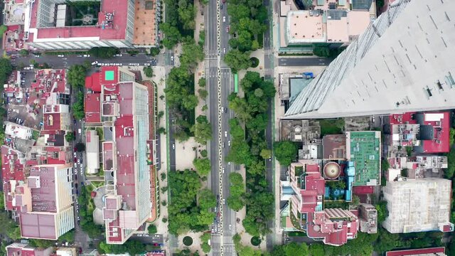 Spectacular high aerial flight past tall torre mayor tower, chapultepec uno, BBVA and reforma skyscrapers in downtown financial district directly above Paseo de la reforma avenue, drone tracking