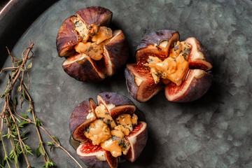 Figs stuffed with goat cheese. Figs with nut and honey cheese. Shallow dof. Figs with nut. blue...
