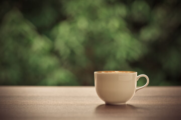 Hot coffee, Latte art on cappuccino coffee cup, with beautiful nature background.
