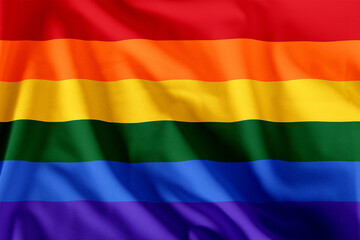 Fabric wavy colorful Rainbow LGBT pride flag background.