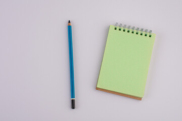 Empty recycle paper notebook and pencil on white background 