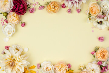 Creative layout made with flowers on vanilla background. Spring minimal concept. Nature background.