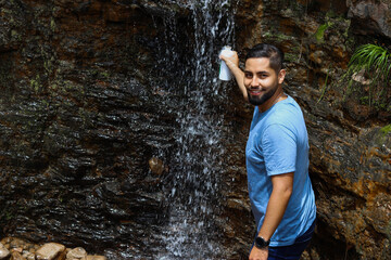 Fototapeta premium young man in the waterfall