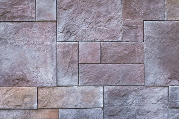 Squares abstract background, stone wall texture, brown tile floor, sidewalk. Granite brick surface. Architecture, masonry design. Grunge wallpaper. Exterior elements. Close-up of a building facade.