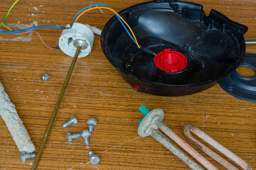er heater. Details of the disassembled boiler on the table. Heating element, anode, thermal sensor.