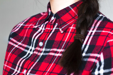 young woman with braid wearing red plaid shirt