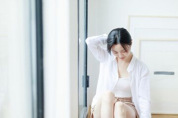 Beautiful young women sitting by the window of Asia

