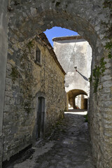 Fototapeta na wymiar A narrow street among the old houses of Cercemaggiore, a medieval village in the Molise region.