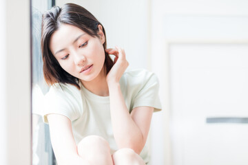 Beautiful young women sitting by the window of Asia

