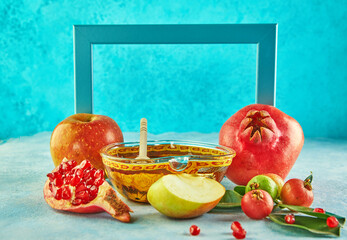 Rosh Hashanah - Jewish New Year holiday concept. Around the frame: A bowl in the form of an apple with honey, pomegranate, shofar - traditional symbols of the holiday