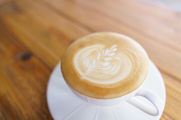 Cup of coffee with latte art pattern milk foam