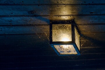 A mystical photograph of a lamp in a web.