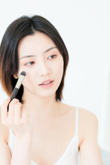 A beautiful young asian woman in make-up

