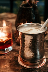 Indian mango lassi in a vintage metallic cup