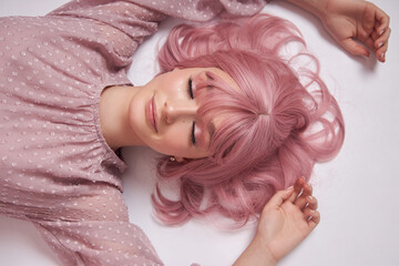 Portrait of a sexy young woman with pink hair. Perfect hairstyle and hair coloring. Girl with...