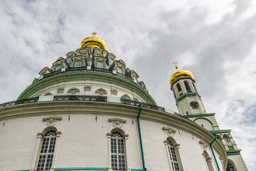 Fototapeta premium Dark clouds over the domes of the monastery