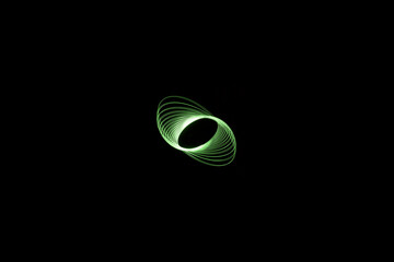 green elliptical light painting photography, long exposure, ripples and waves against a black background