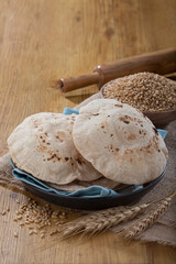 Indian bread (Roti) on a wooden base along with the props.