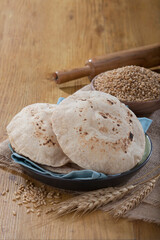 Indian bread (Roti) on a wooden base along with the props.