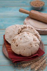 Indian bread (Roti) on a wooden base along with the props.