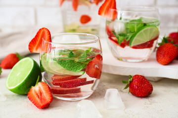 Glass of tasty strawberry mojito on table