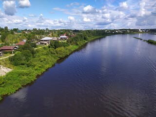 Fototapeta na wymiar View of a small Russian town Totma and wide calm river from a high bridge