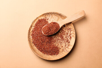 Plate and spoon with healthy quinoa on color background