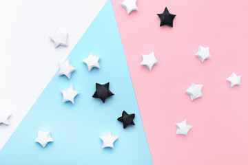 Black and white paper stars on color background. Racism concept