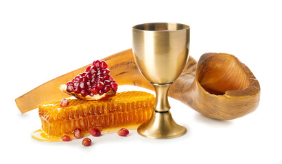 Shofar, sacramental goblet with wine, honey and pomegranate on white background. Rosh Hashanah (Jewish New Year) celebration