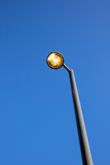streetlamp against blue sky