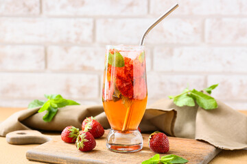 Glass of tasty strawberry cocktail on table