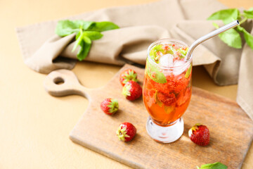 Glass of tasty strawberry cocktail on color background