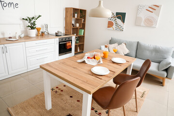 Interior of modern stylish kitchen with dining table