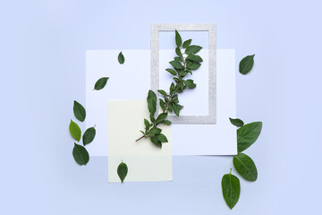 Composition with green leaves on light background