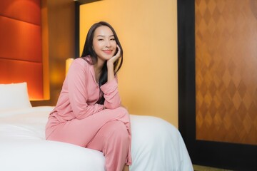 Portrait beautiful young asian woman relax smile happy on bed