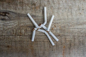 Extinguished cigarettes lie on a wooden surface. Cigarettes are addictive. Campaign to reduce...