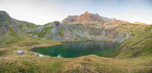 Fototapeta na wymiar Panoramic view of the ibon of sabocos in the pyrenees, refuge by the lake