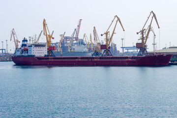 Part of sea cargo port with ship on the foreground