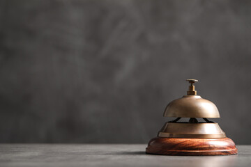 Hotel service bell on grey table. Space for text