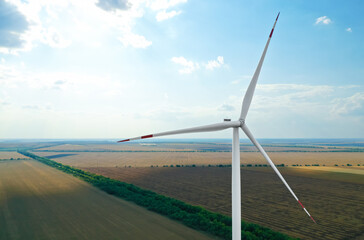 Modern windmill in wide field. Energy efficiency