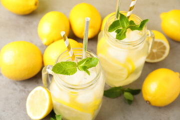 Natural freshly made lemonade and mint on light grey table. Summer refreshing drink