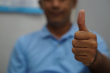 A man showing his thumb.