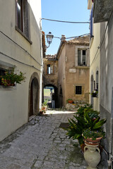 Fototapeta na wymiar A narrow street among the old houses of Riccia, a medieval village in the Molise region.
